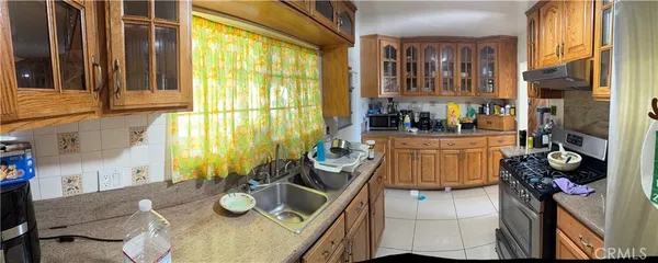 a dining room with furniture and a floor to ceiling window