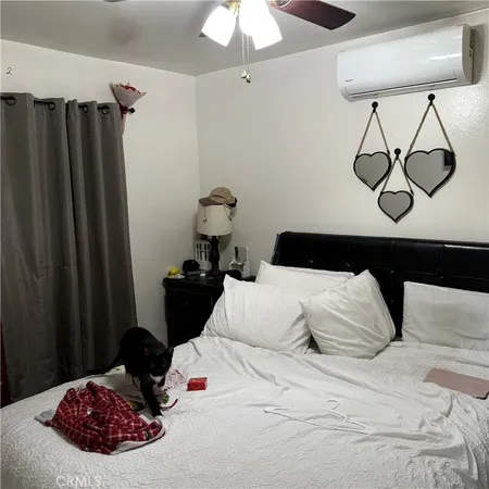 a bedroom with a bed and a chandelier
