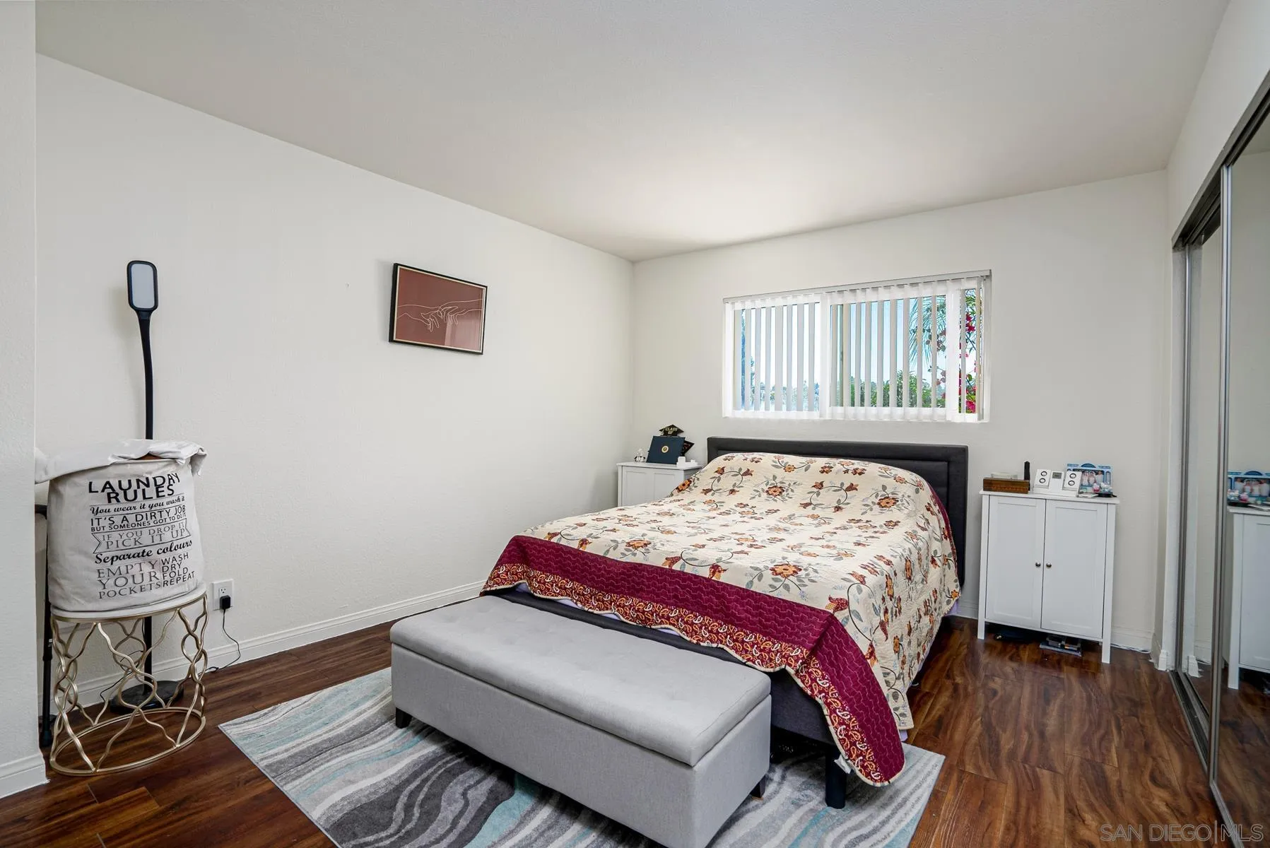 9860 Dale Avenue, Unit D7 Spring Valley, CA 91977 - Photo 12 of 19 a bedroom with a bed and wooden floor