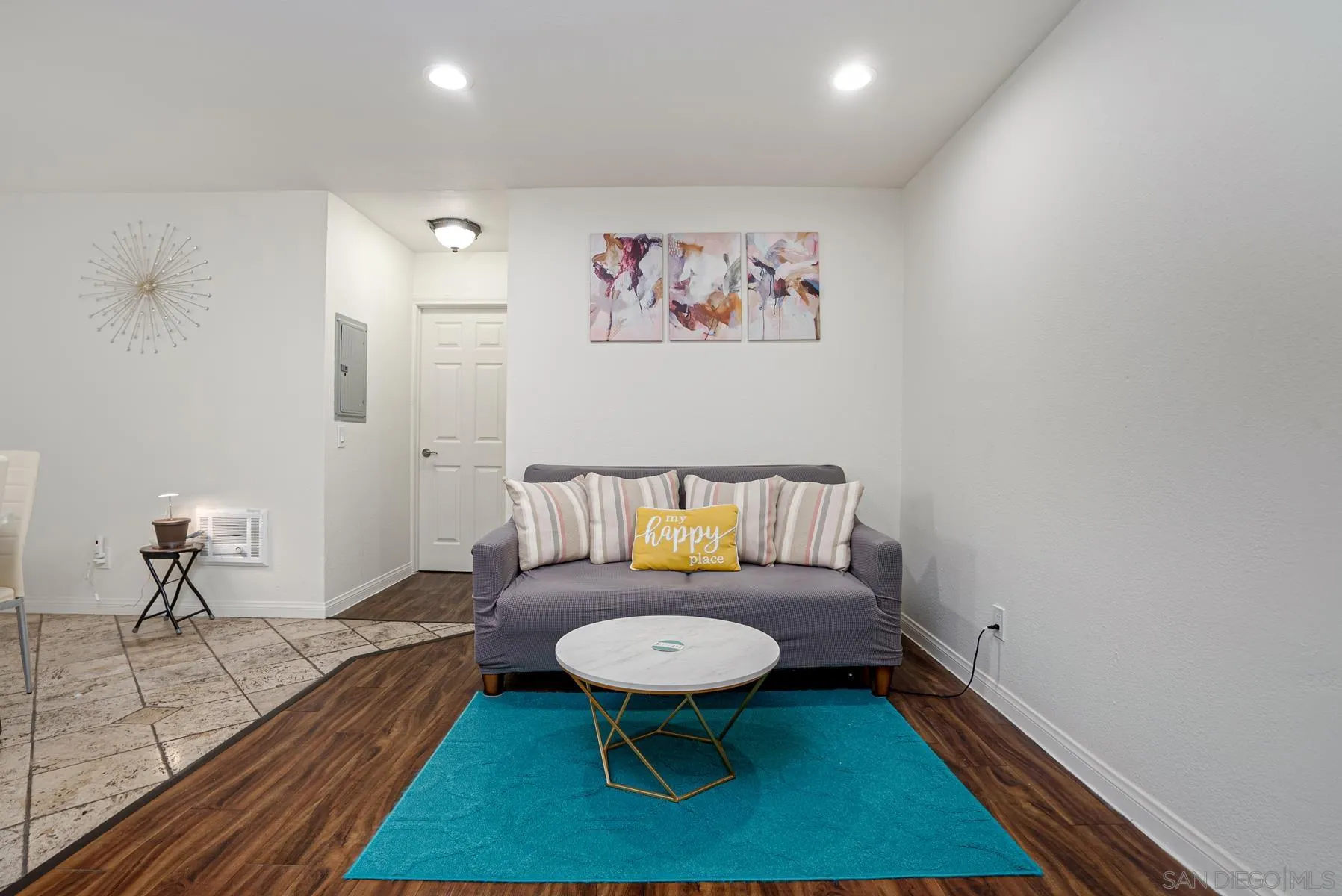 9860 Dale Avenue, Unit D7 Spring Valley, CA 91977 - Photo 3 of 19 a living room with furniture a rug and a wall painting
