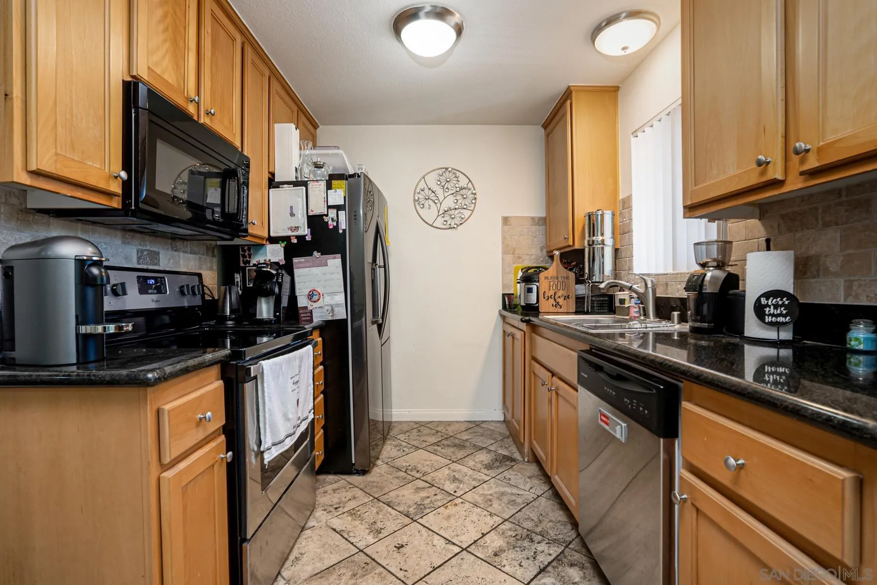 9860 Dale Avenue, Unit D7 Spring Valley, CA 91977 - Photo 8 of 19 a kitchen with stainless steel appliances granite countertop a refrigerator and a sink
