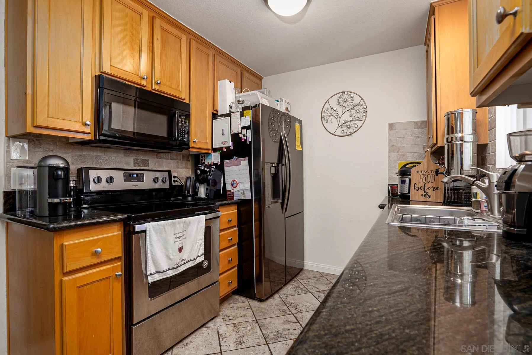 9860 Dale Avenue, Unit D7 Spring Valley, CA 91977 - Photo 10 of 19 a kitchen with stainless steel appliances granite countertop a refrigerator and a stove top oven