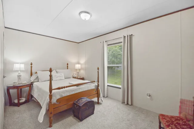 a bedroom with a bed and a night stand