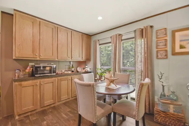 a kitchen with a table chairs sink and cabinets