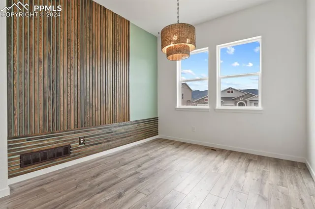 an empty room with wooden floor wooden floor and windows