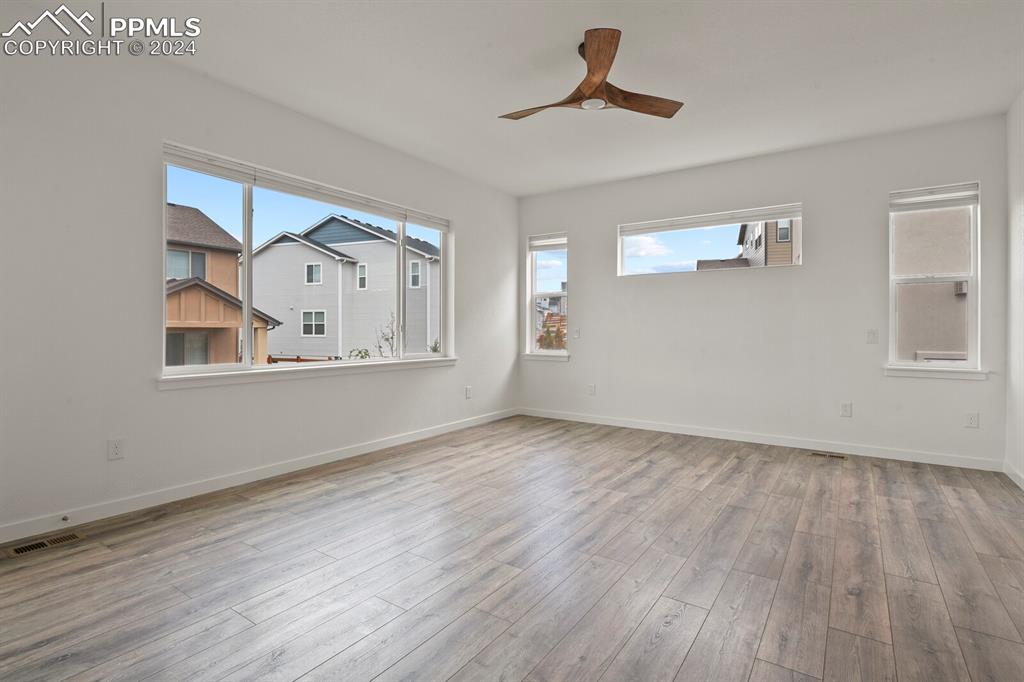 1094 Rambling Oak Drive Monument, CO 80132 - Photo 19 of 44 a view of empty room with wooden floor and fan