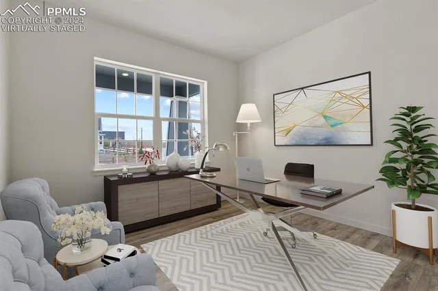 a living room with furniture a table and a potted plant