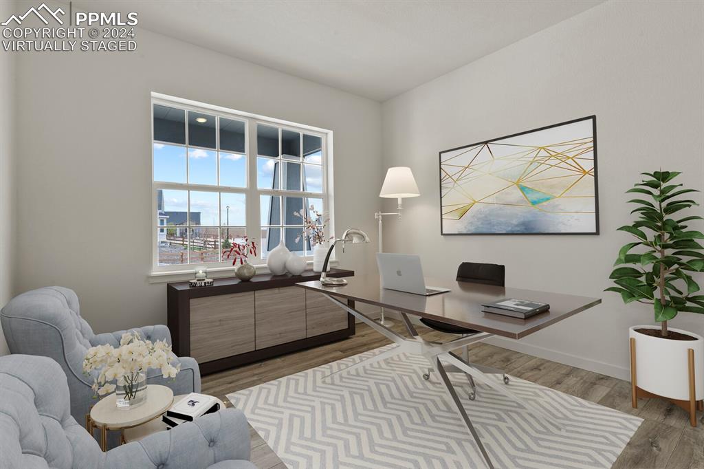 1094 Rambling Oak Drive Monument, CO 80132 - Photo 23 of 44 a living room with furniture a table and a potted plant