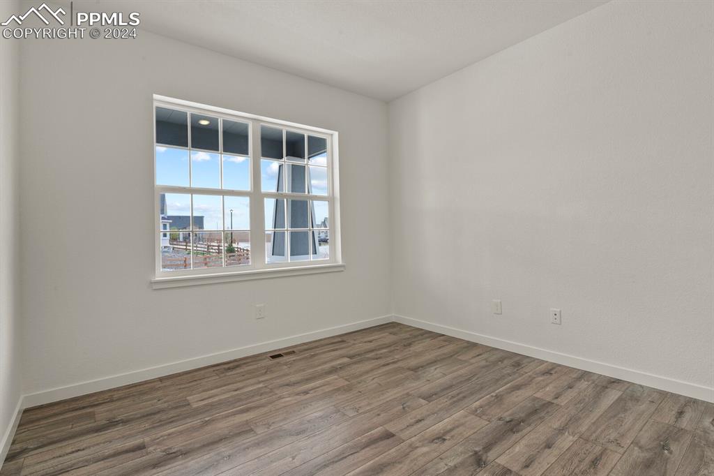 1094 Rambling Oak Drive Monument, CO 80132 - Photo 24 of 44 a view of empty room with wooden floor and fan
