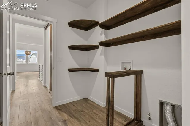 a view of hallway with wooden floor