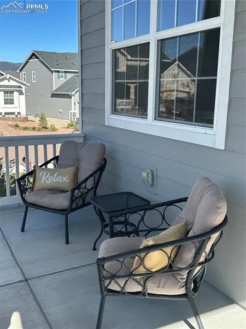 a view of a chairs and table in back of the house