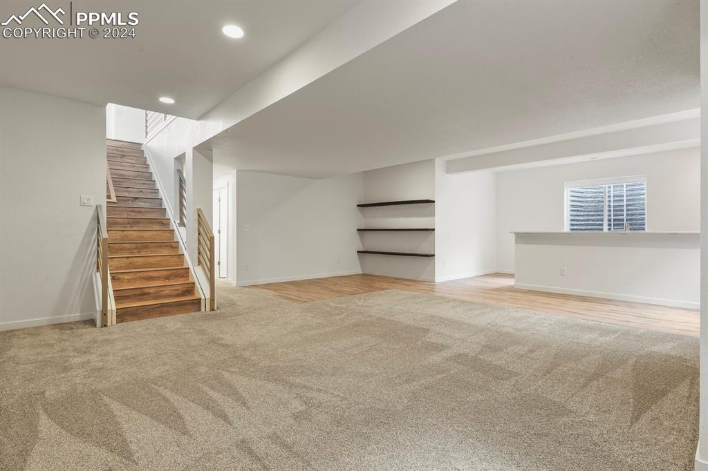 1094 Rambling Oak Drive Monument, CO 80132 - Photo 33 of 44 a view of an empty room with wooden floor and stairs