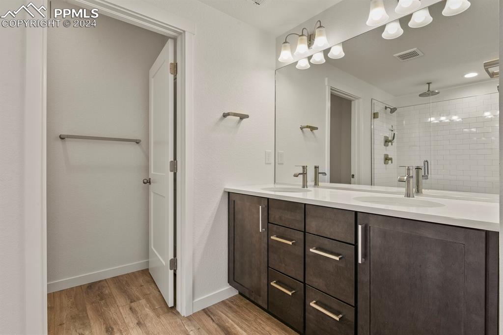 1094 Rambling Oak Drive Monument, CO 80132 - Photo 41 of 44 a bathroom with a double vanity sink and a mirror