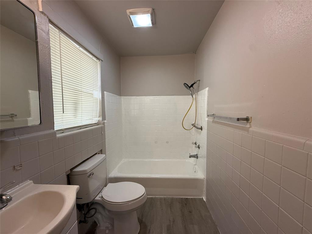 10 Pershing Drive, Unit A Denison, TX 75020 - Photo 11 of 13 a bathroom with a sink toilet and shower