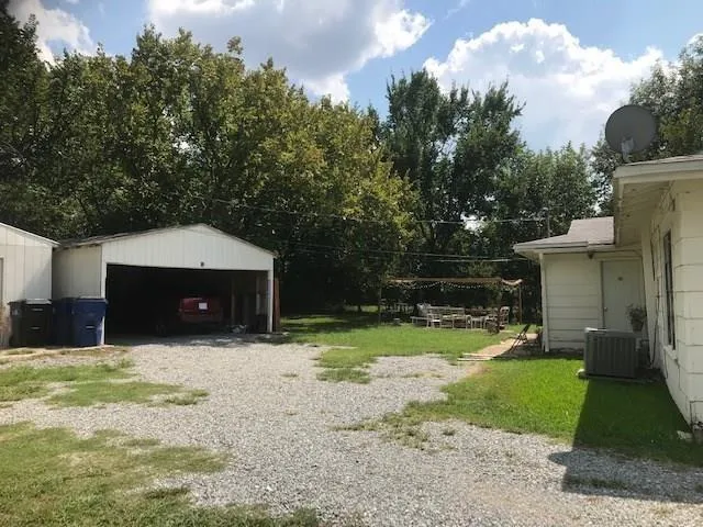 a backyard of a house with a yard and garage