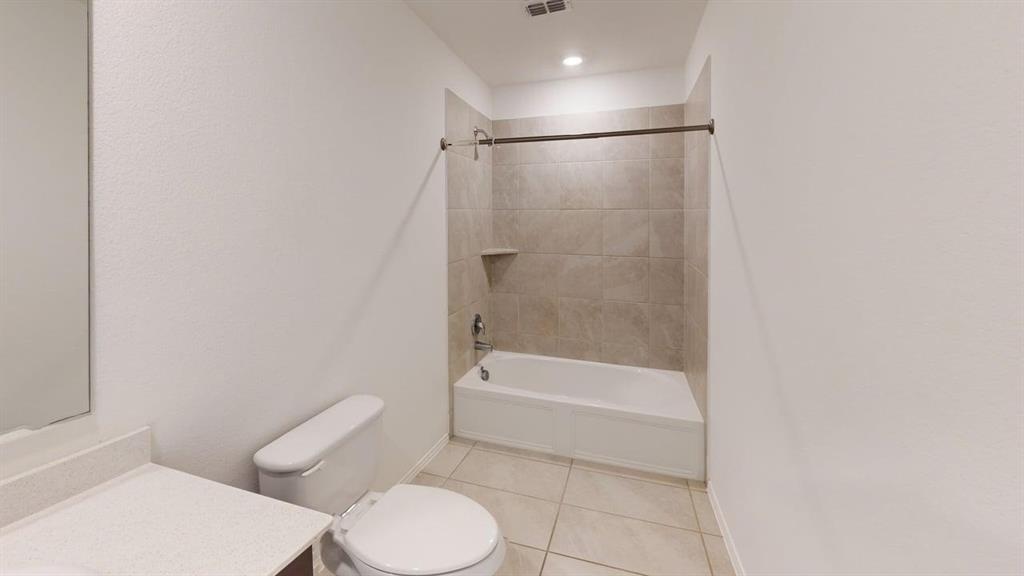 3801 Harper Street Little Elm, TX 75068 - Photo 15 of 17 a bathroom with a toilet and a shower