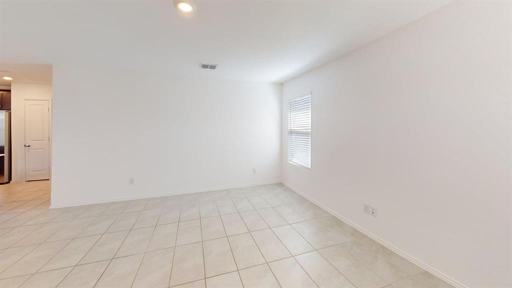 3801 Harper Street Little Elm, TX 75068 - Photo 7 of 17 an empty room with white walls and tiles