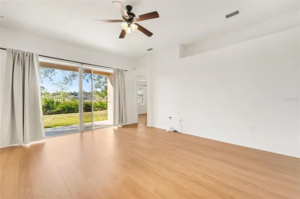 a view of room with wooden floor and fan