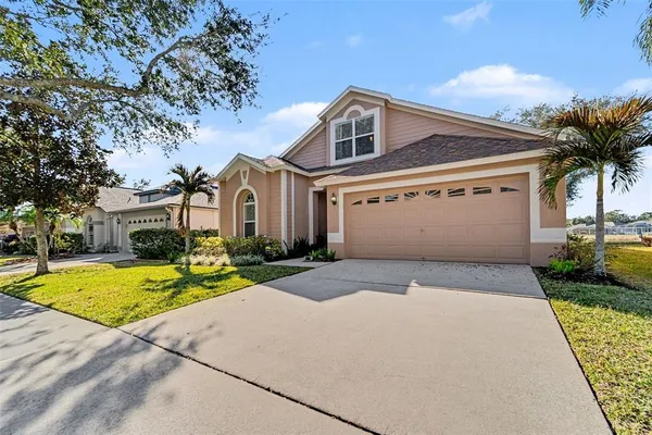 a front view of a house with a yard and garage