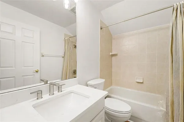 a bathroom with a sink toilet vanity and shower