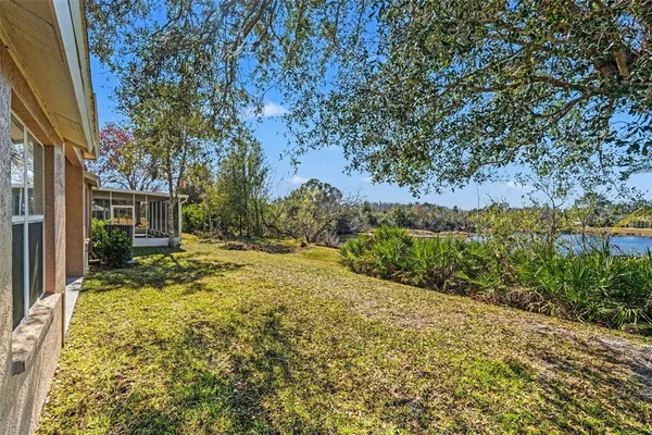a view of a lake with house in background