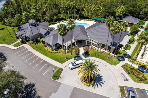 a kitchen with granite countertop a stove a sink dishwasher a dining table and chairs with wooden floor