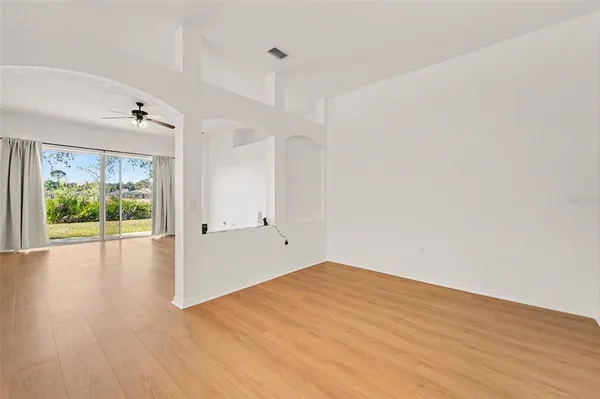 wooden floor in an empty room with a window