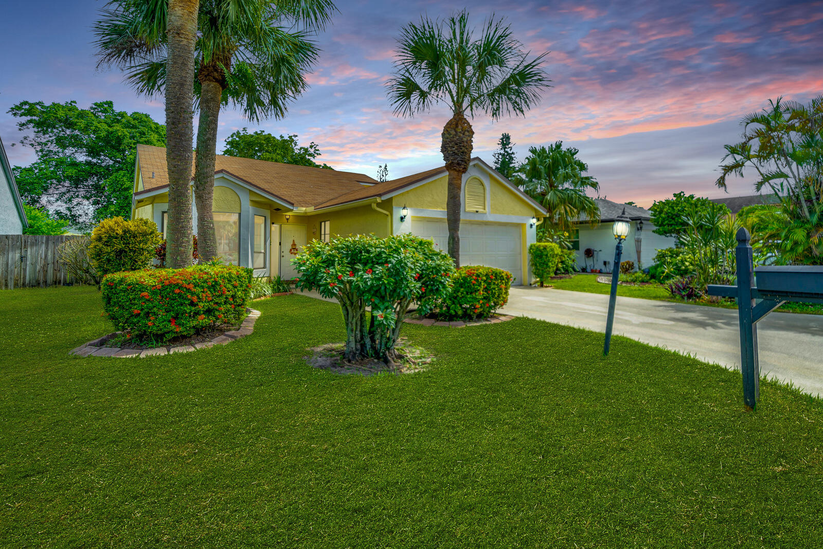 a front view of house with yard and green space