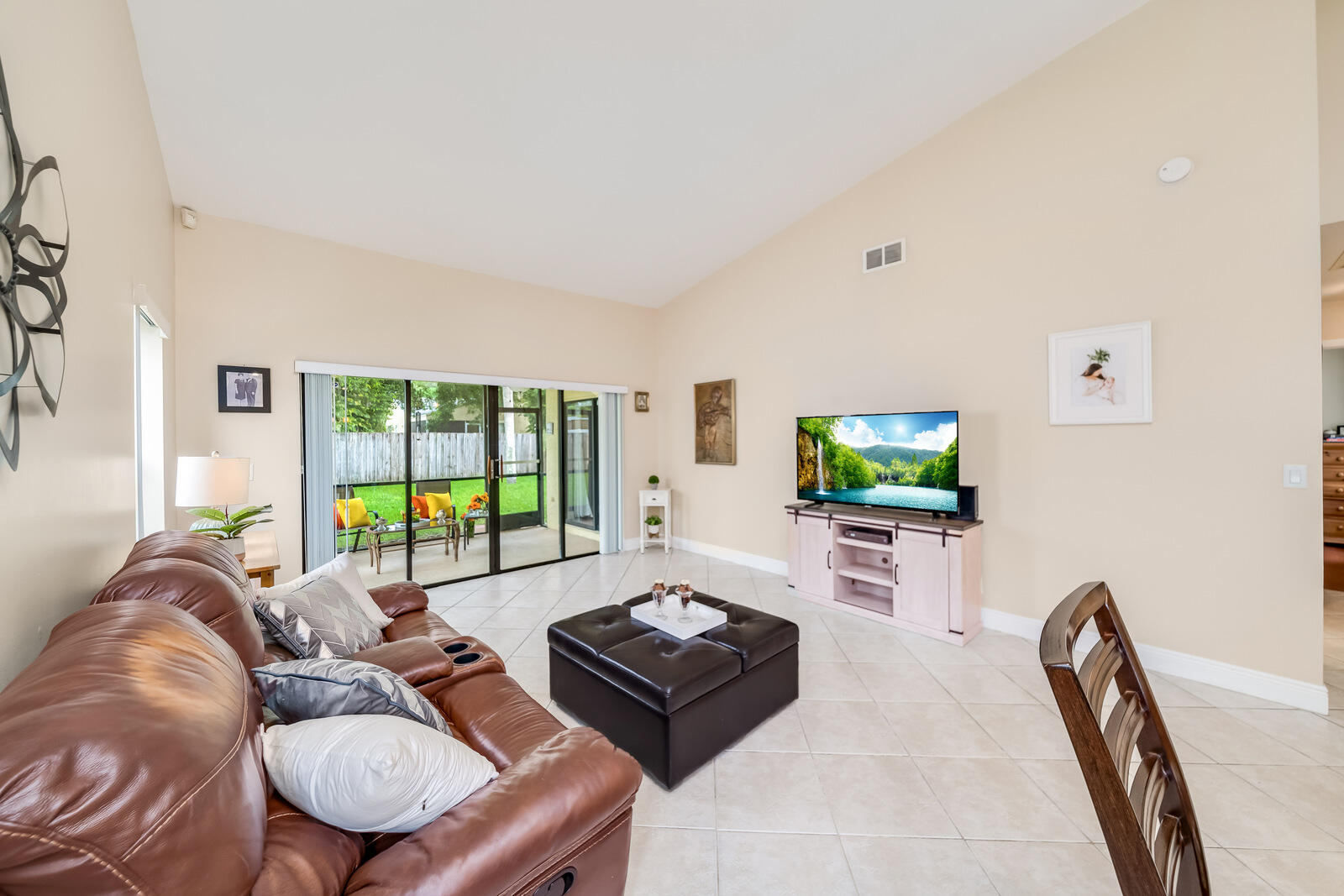 23250 Sedawie Drive Boca Raton, FL 33433 - Photo 11 of 42 a living room with furniture a flat screen tv and a large window