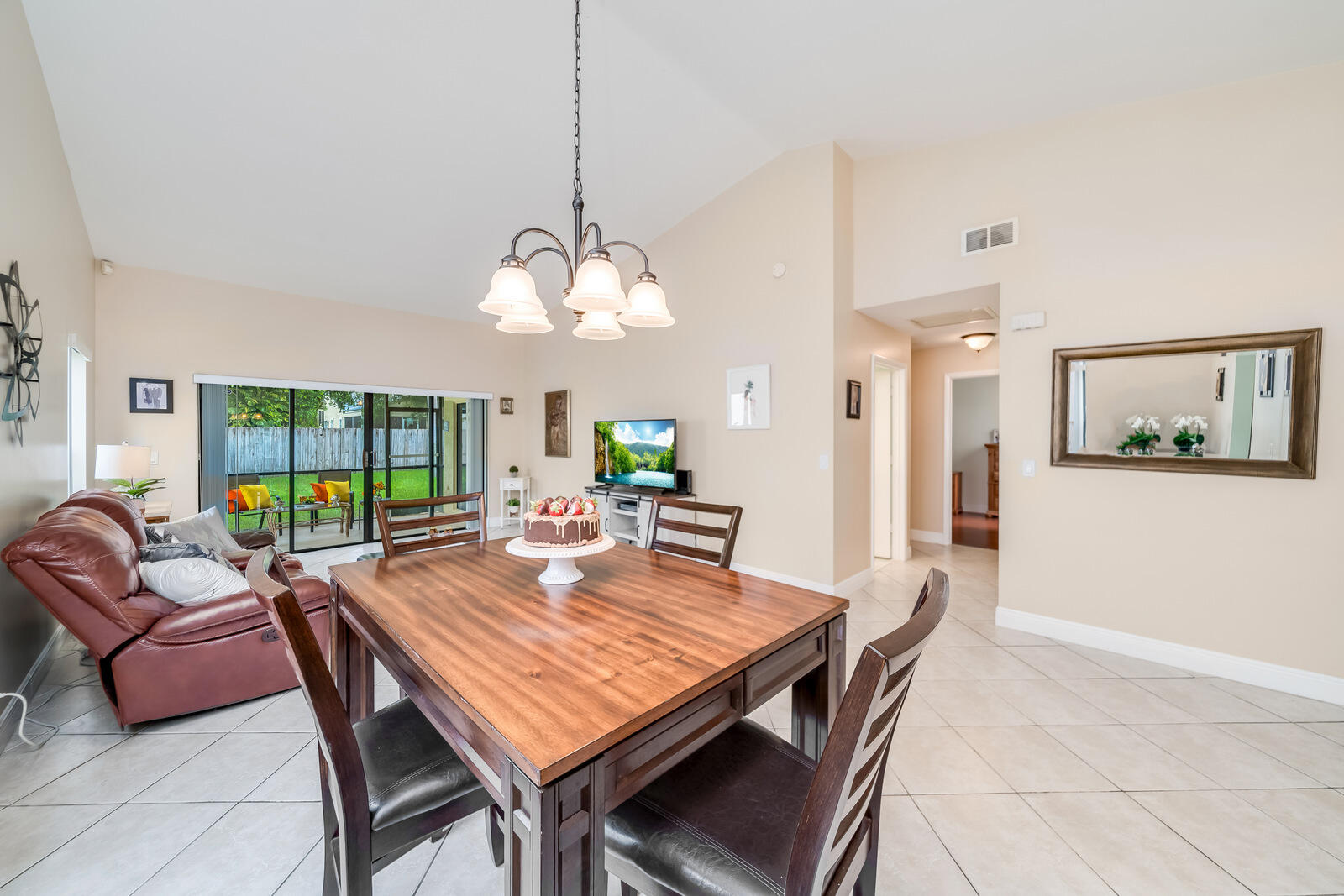 23250 Sedawie Drive Boca Raton, FL 33433 - Photo 12 of 42 a view of a dining room with furniture wooden floor and a chandelier