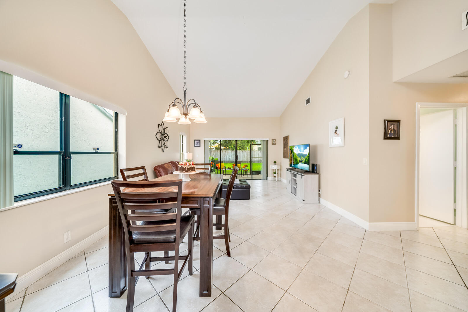 23250 Sedawie Drive Boca Raton, FL 33433 - Photo 13 of 42 a view of a dining room with furniture and chandelier