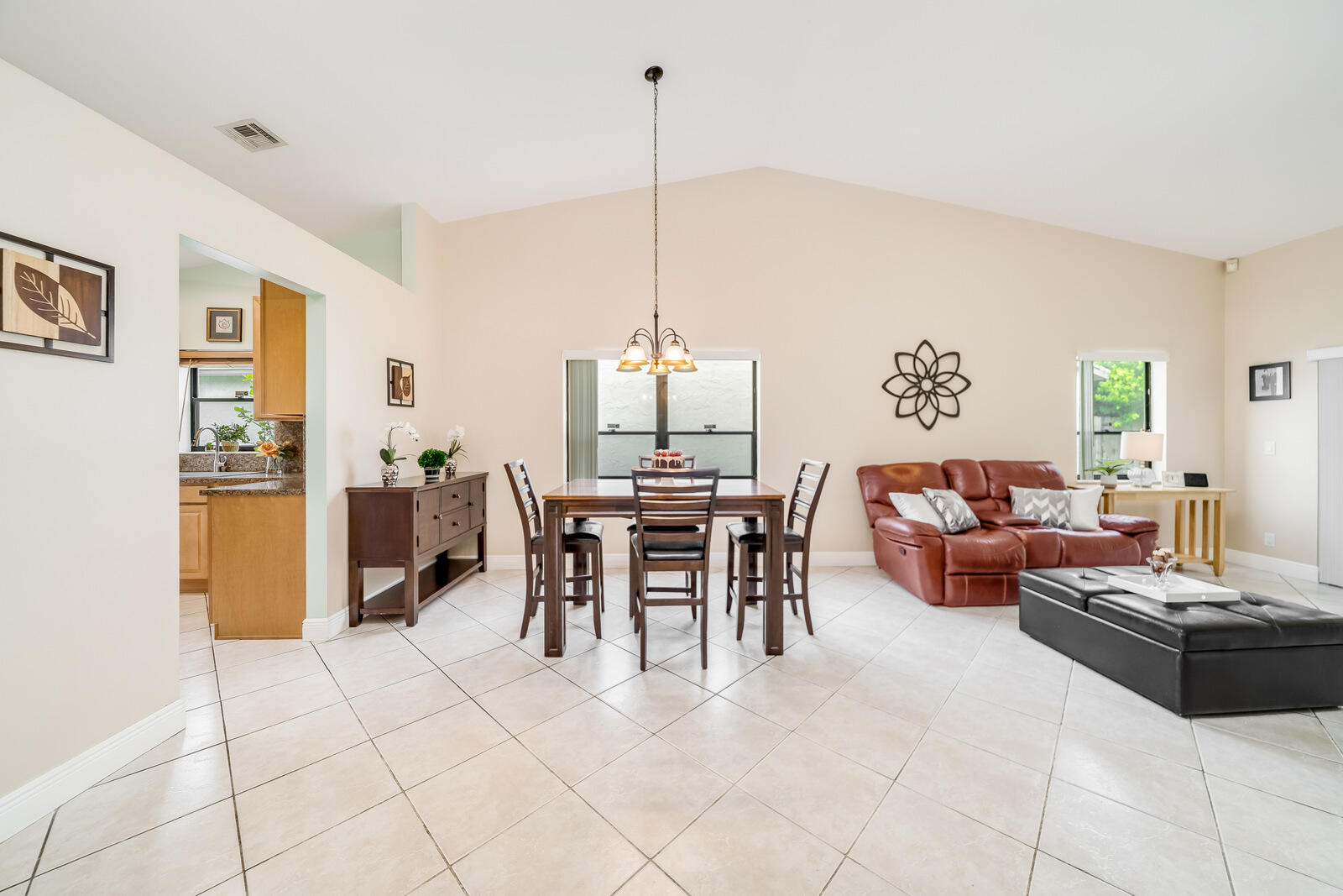 23250 Sedawie Drive Boca Raton, FL 33433 - Photo 14 of 42 a dining room with furniture and a chandelier