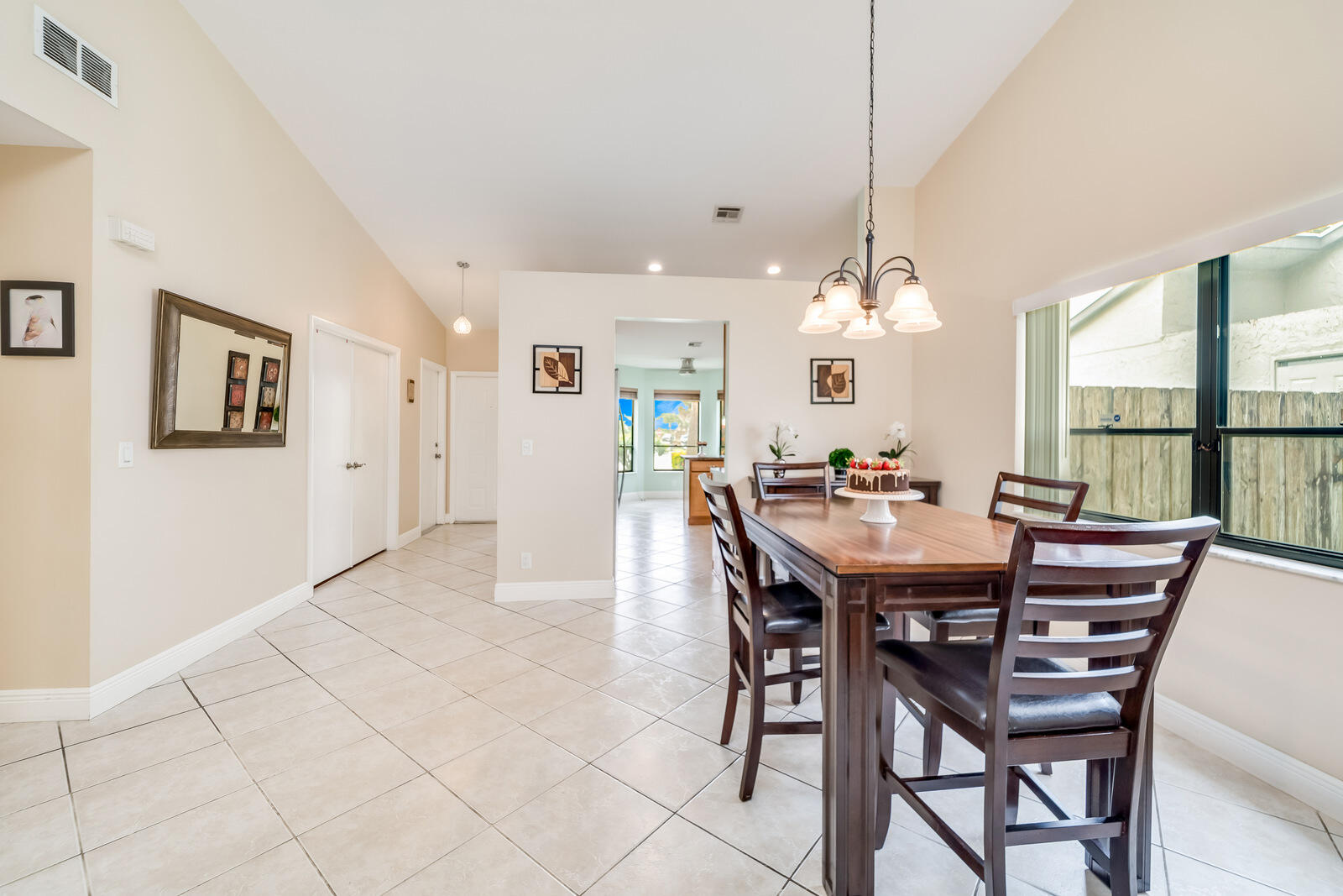 23250 Sedawie Drive Boca Raton, FL 33433 - Photo 15 of 42 a view of a dining room with furniture and a large window