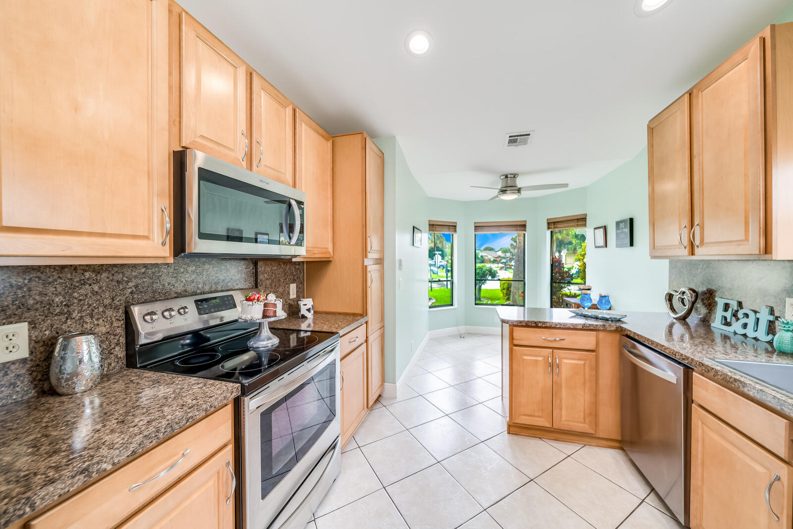 23250 Sedawie Drive Boca Raton, FL 33433 - Photo 19 of 42 a kitchen with a sink a stove and cabinets