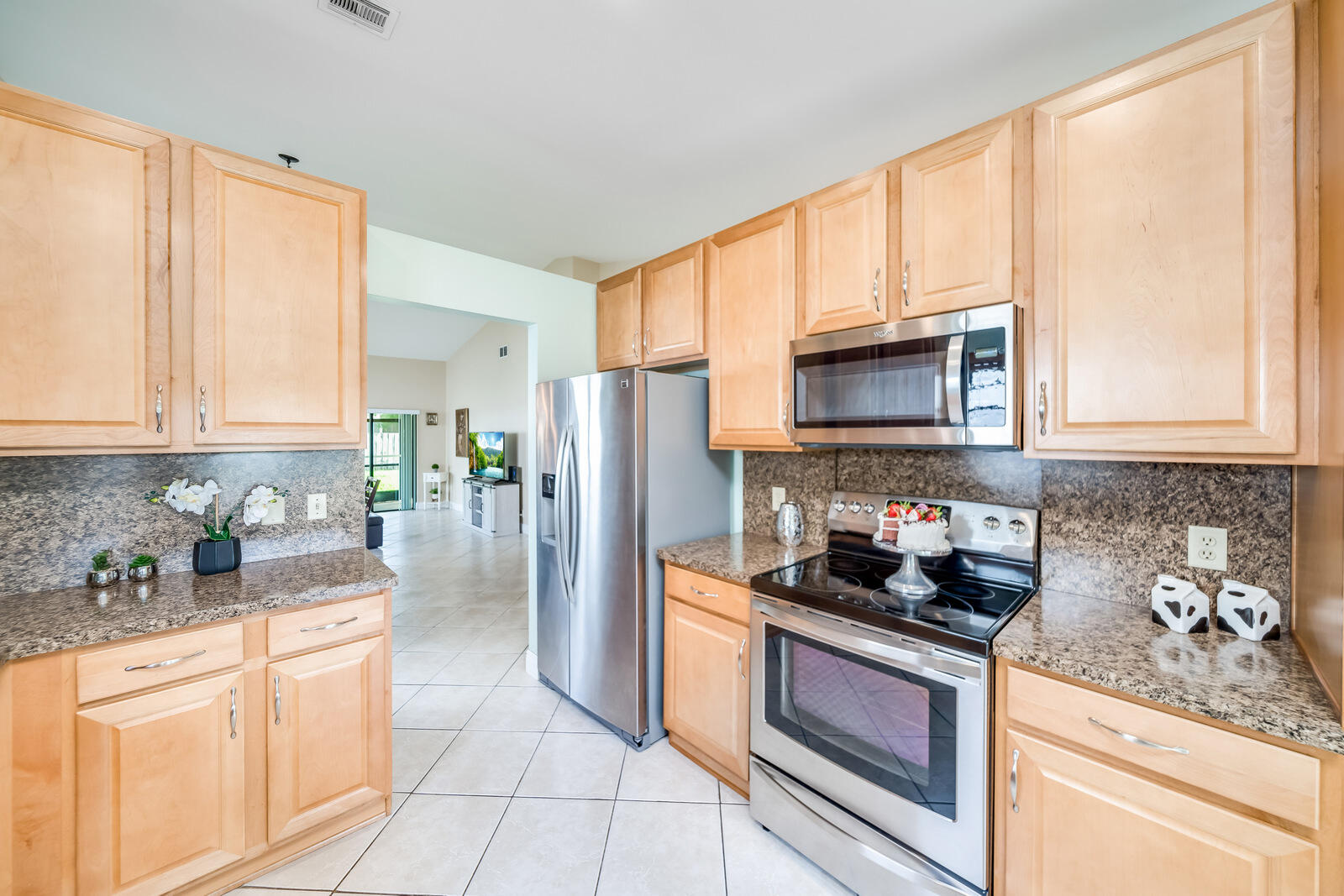 23250 Sedawie Drive Boca Raton, FL 33433 - Photo 22 of 42 a kitchen with stainless steel appliances granite countertop a stove a sink and a refrigerator