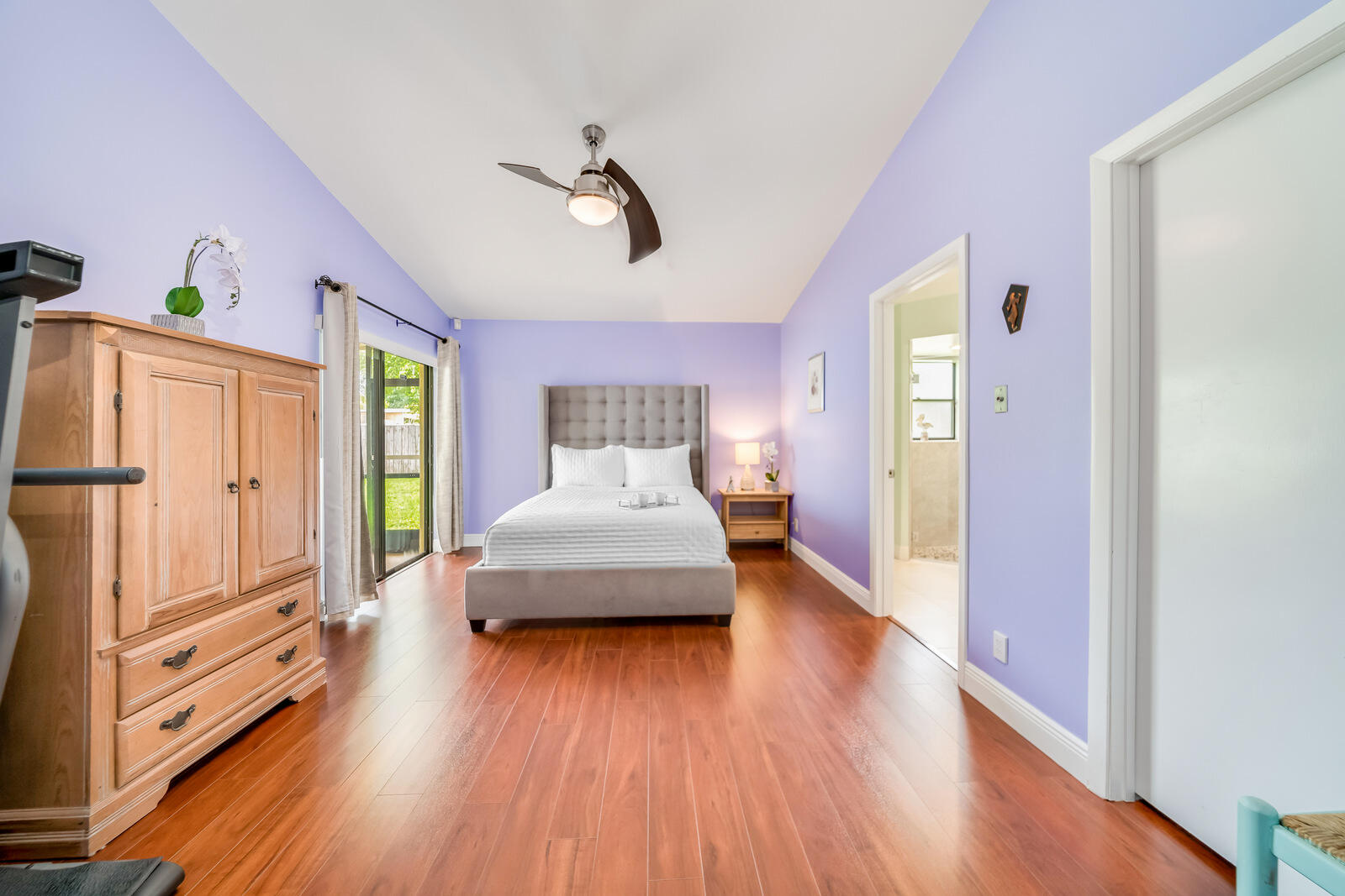 23250 Sedawie Drive Boca Raton, FL 33433 - Photo 24 of 42 a bedroom with a bed and wooden floor