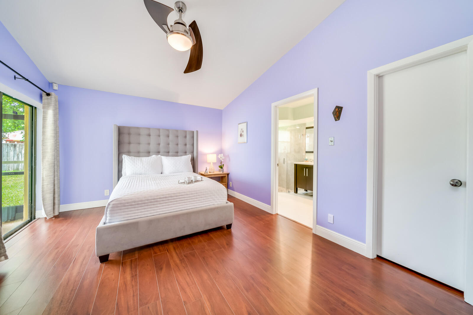 23250 Sedawie Drive Boca Raton, FL 33433 - Photo 25 of 42 a bedroom with a bed and wooden floor