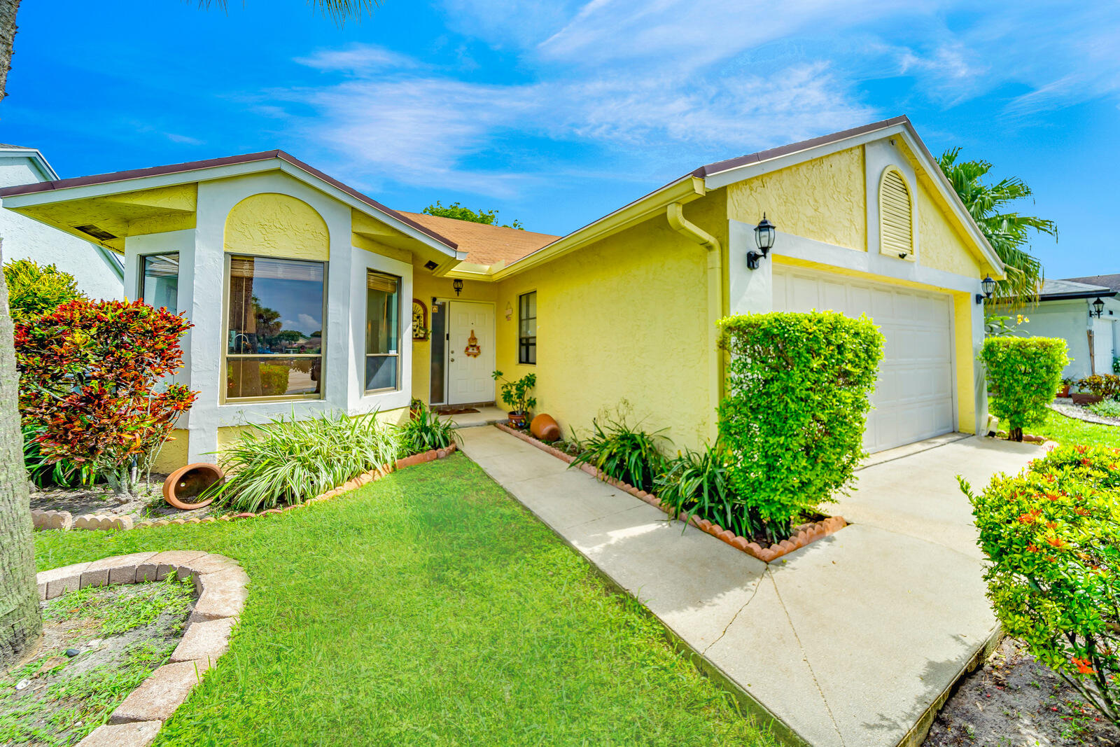 23250 Sedawie Drive Boca Raton, FL 33433 - Photo 6 of 42 a front view of a house with garden