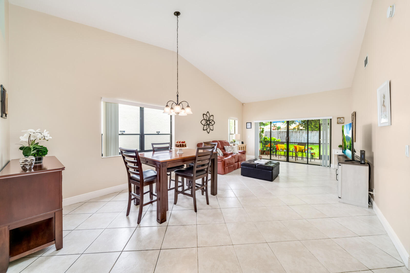 23250 Sedawie Drive Boca Raton, FL 33433 - Photo 8 of 42 a view of a dining room and livingroom with furniture wooden floor a chandelier