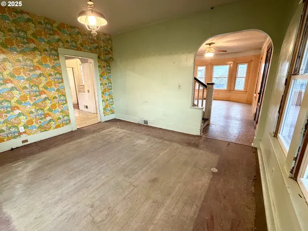an empty room with wooden floor and door