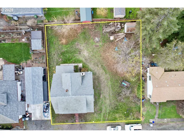 an aerial view of a house with a yard