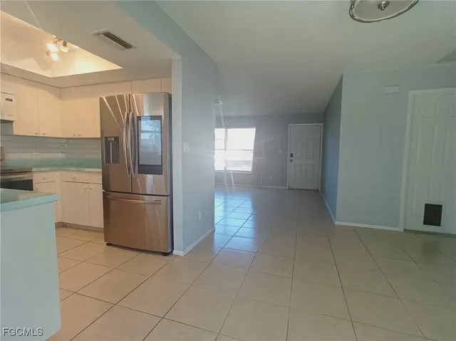 a kitchen with a refrigerator and microwave