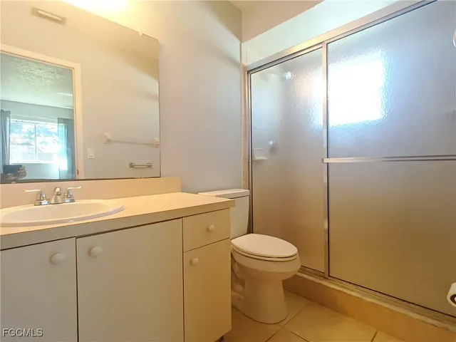 a bathroom with a sink mirror vanity and toilet