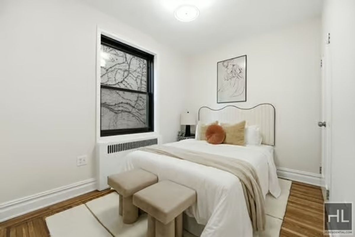 160 East 3rd Street, Unit 2F Manhattan, NY 10009 - Photo 12 of 20 a bedroom with a bed and wooden floor