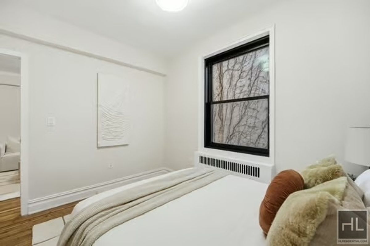 160 East 3rd Street, Unit 2F Manhattan, NY 10009 - Photo 13 of 20 a bedroom with a bed and window