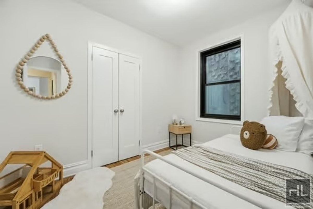 160 East 3rd Street, Unit 2F Manhattan, NY 10009 - Photo 14 of 20 a bedroom with a bed and a window