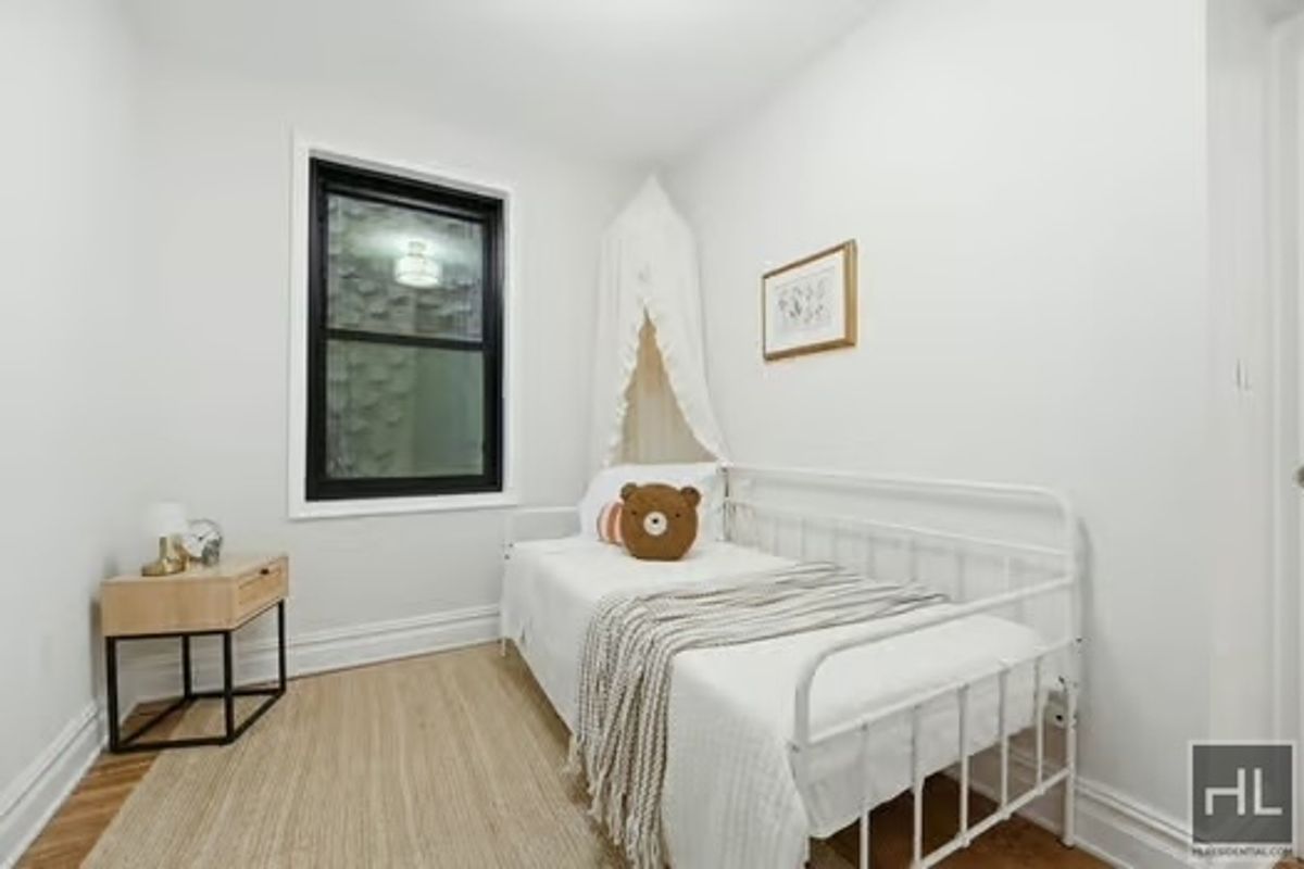 160 East 3rd Street, Unit 2F Manhattan, NY 10009 - Photo 15 of 20 a bedroom with a bed and a window