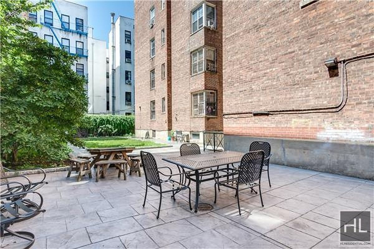 160 East 3rd Street, Unit 2F Manhattan, NY 10009 - Photo 20 of 20 a patio with table and chairs and potted plants