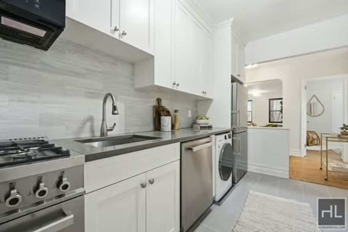 160 East 3rd Street, Unit 2F Manhattan, NY 10009 - Photo 7 of 20 a kitchen with stainless steel appliances granite countertop a sink stove and cabinets