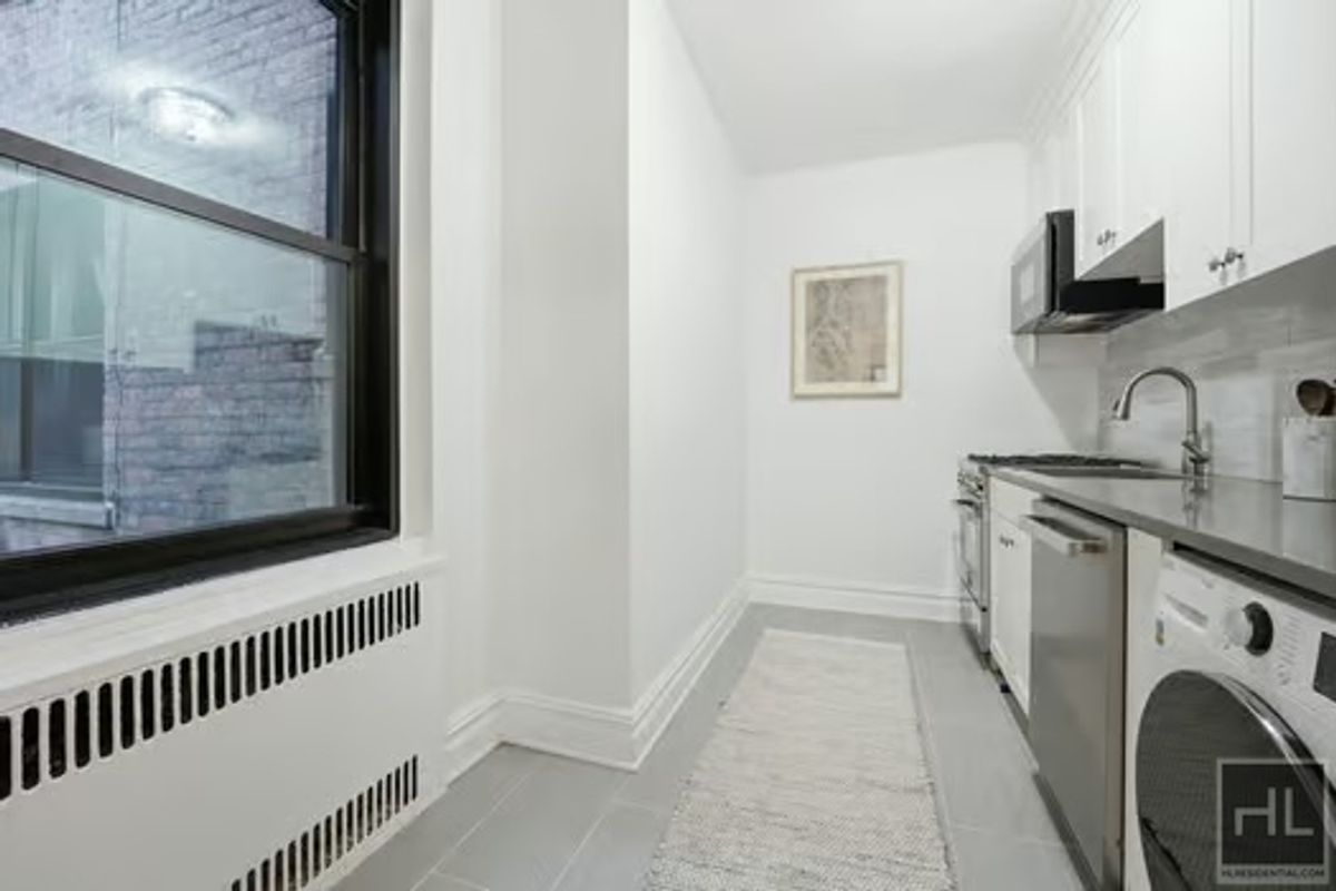 160 East 3rd Street, Unit 2F Manhattan, NY 10009 - Photo 10 of 20 a hallway with washer and dryer